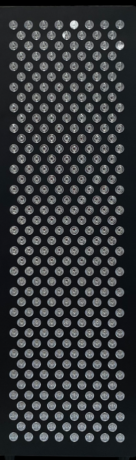 Black rectangular object with a textured surface on a black background